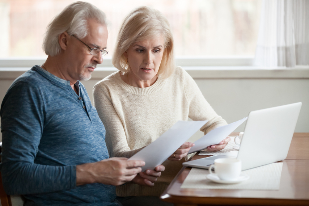 Senior couple reviewing a mortgage contract