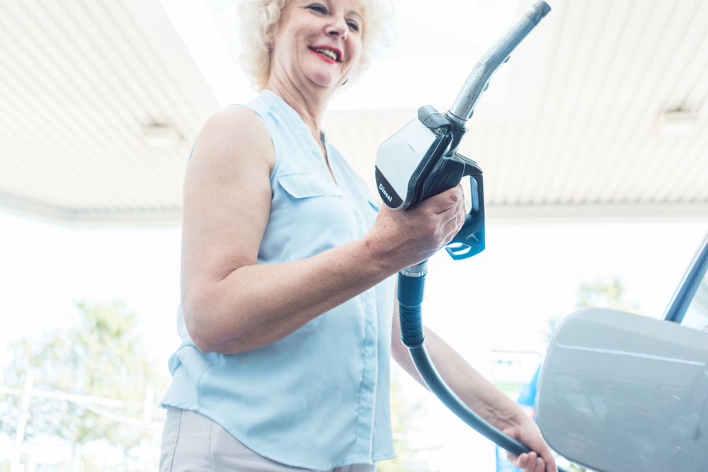 Senior woman at a gas station
