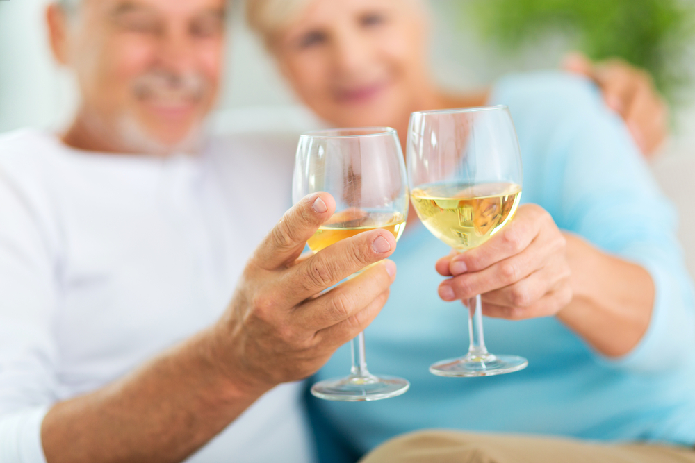 Seniors couple having a glass of wine